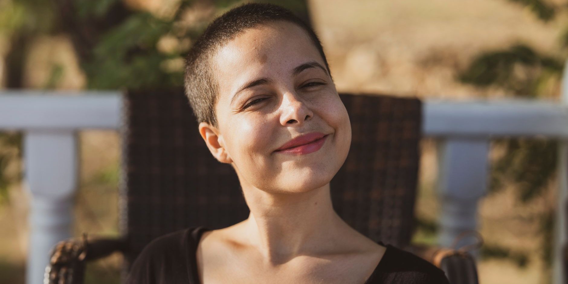 A woman smiling on a porch