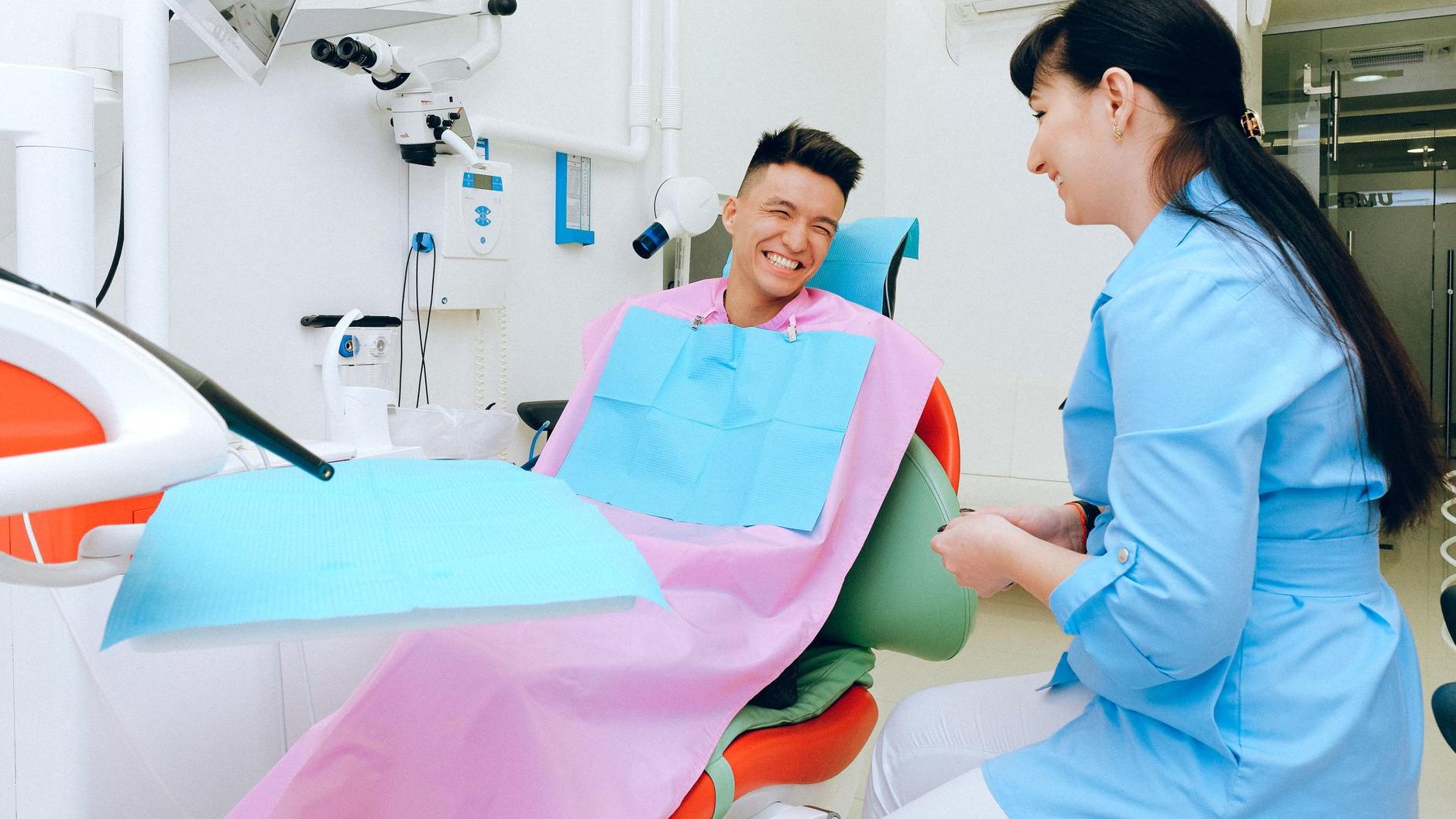 A patient laughing with the dental assistant from the treatment chair