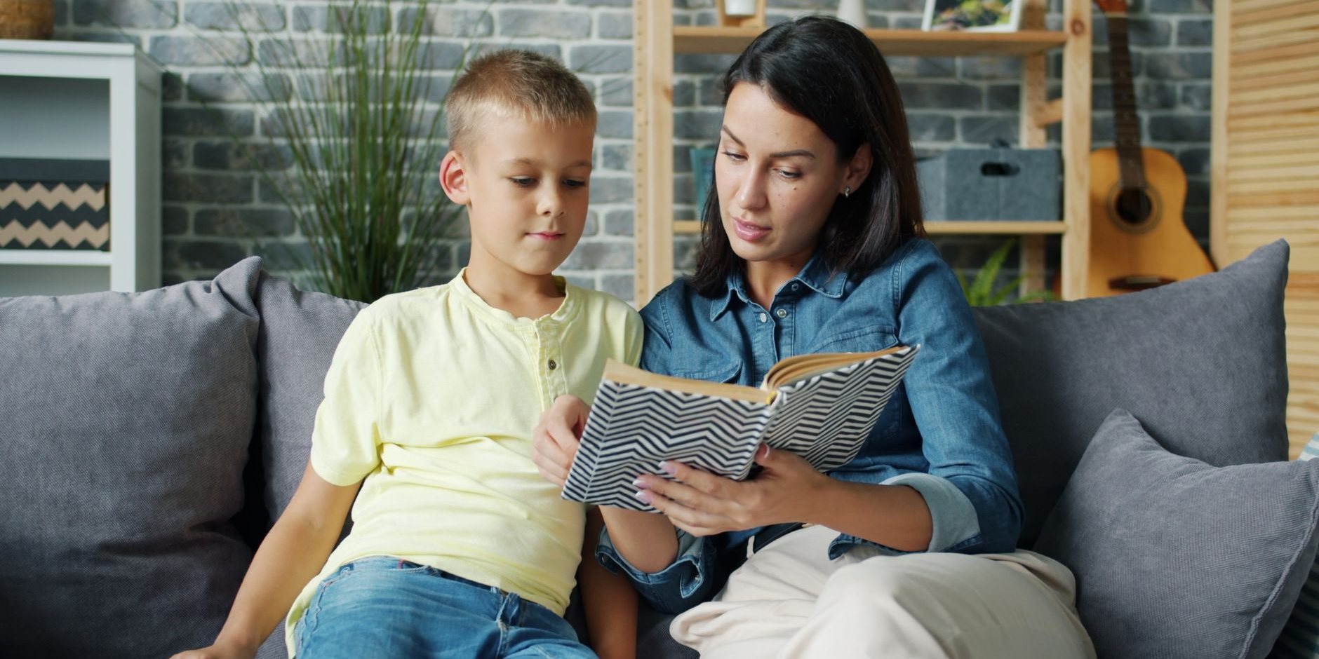 A mother and son reading together