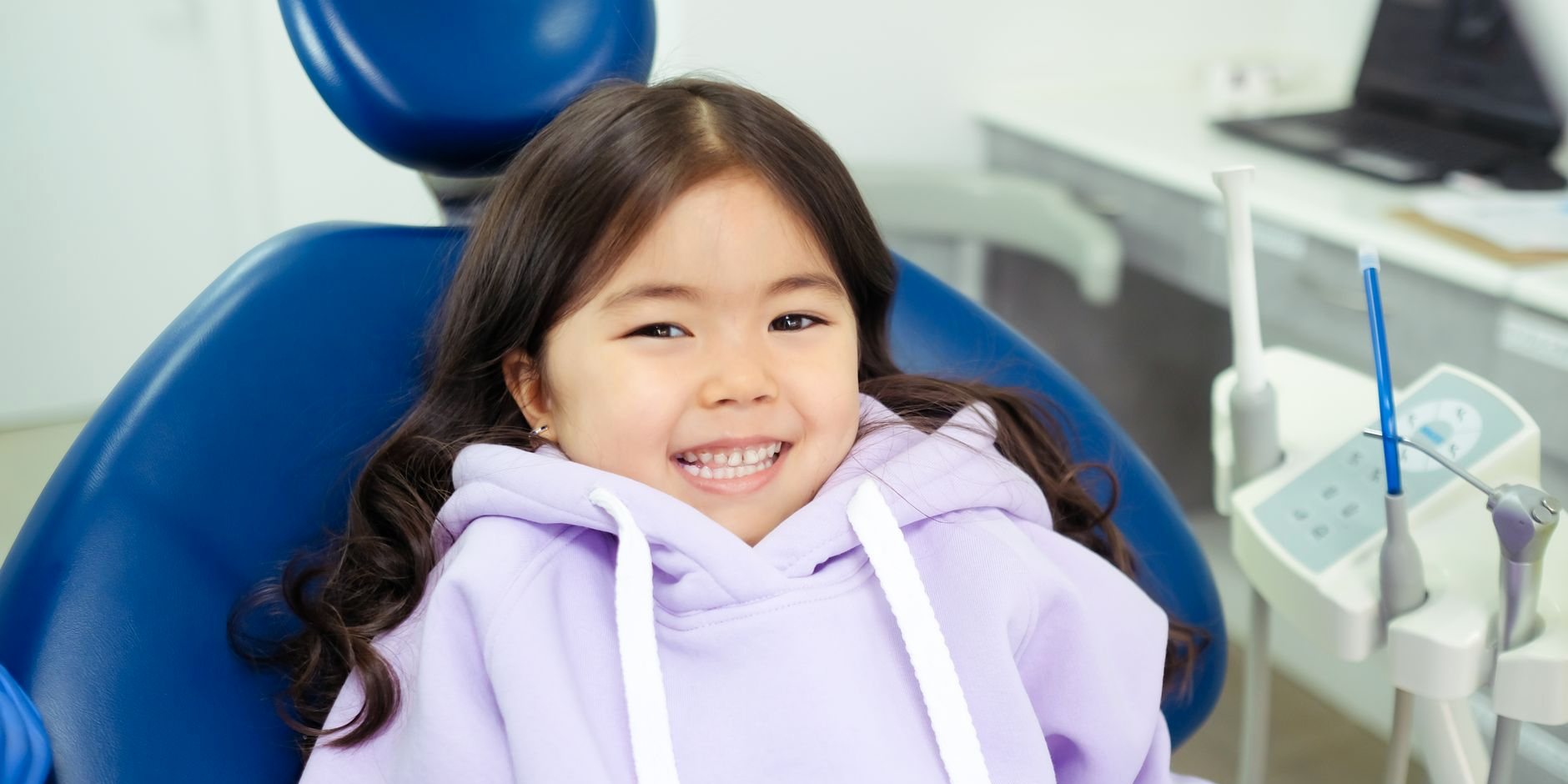 A young girl smiling in the dental chair