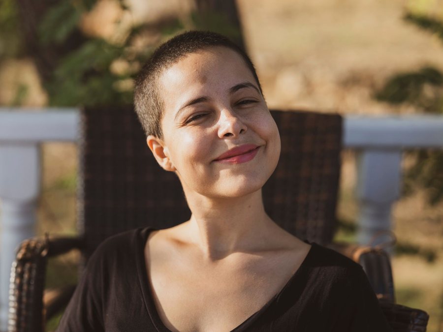 A woman smiling on a porch