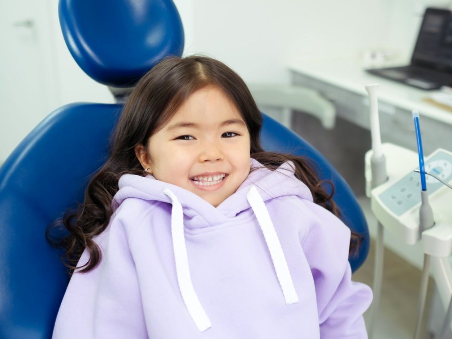 A young girl smiling in the dental chair